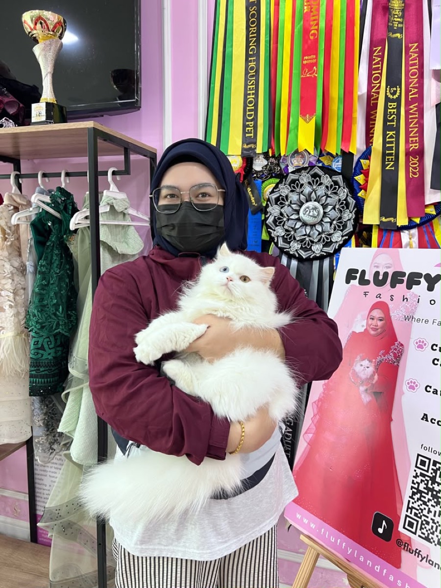 Fluffy Land staff with an award-winning cat